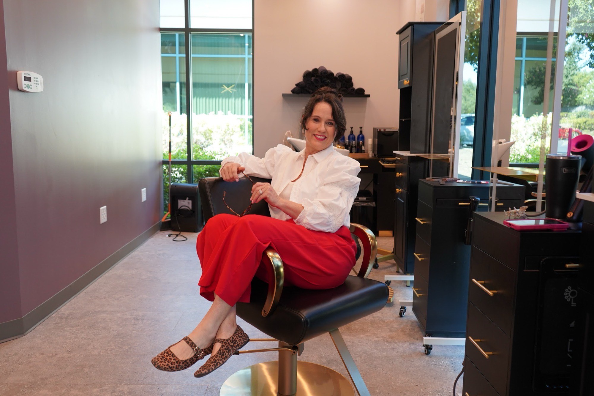 Dawn Bacchi seated in her styling chair in the Granite Bay studio